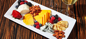Cheese and wine platter on white ceramic plate